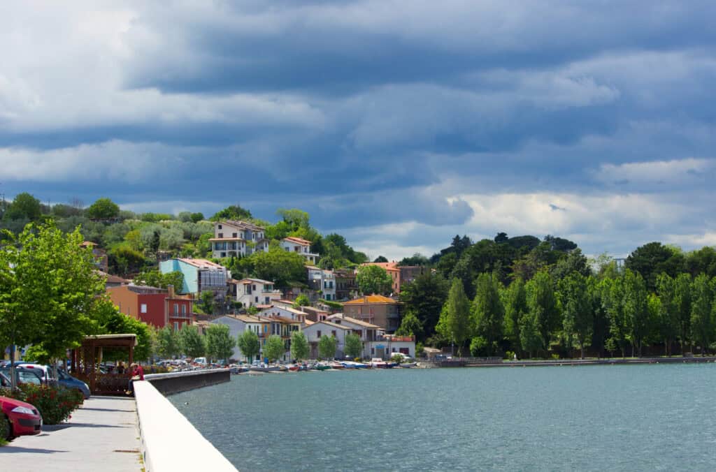Scenic view of Bolsena Lake with colorful houses and a cloudy sky